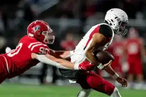 Westside High School quarterback Anthony Rezac (5) runs for a first down past Millard South's Nathan Thompson during a game between the Millard South and Omaha Westside in Omaha, NE on Sunday October 13th, 2023. Photo by Eric Francis