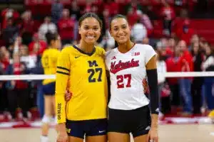 Sisters Nebraska Cornhusker Harper Murray (27) and Michigan Wolverine Kendall Murray (27) pose for a photo after the volleyball match on Friday, November 17, 2023, in Lincoln, Nebraska. Photo by John S. Peterson.