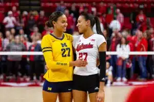 Sisters Nebraska Cornhusker Harper Murray (27) and Michigan Wolverine Kendall Murray (27) pose for a photo after the volleyball match on Friday, November 17, 2023, in Lincoln, Nebraska. Photo by John S. Peterson.