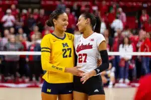 Sisters Nebraska Cornhusker Harper Murray (27) and Michigan Wolverine Kendall Murray (27) pose for a photo after the volleyball match on Friday, November 17, 2023, in Lincoln, Nebraska. Photo by John S. Peterson.