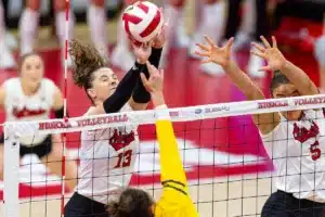Nebraska Cornhusker Merritt Beason (13) blocks a shot against the Michigan Wolverines in the third set during the volleyball match on Friday, November 17, 2023, in Lincoln, Nebraska. Photo by John S. Peterson.