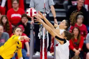 Nebraska Cornhusker Bekka Allick (5) and Merritt Beason (13) block a shot from Michigan Wolverine Valentina Vaulet (13) in the third set during the volleyball match on Friday, November 17, 2023, in Lincoln, Nebraska. Photo by John S. Peterson.