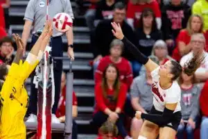 Nebraska Cornhusker Merritt Beason (13) spikes the ball against the Michigan Wolverines in the third set during the volleyball match on Friday, November 17, 2023, in Lincoln, Nebraska. Photo by John S. Peterson.