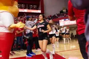 Nebraska Cornhusker Lexi Rodriguez (8) leads the Huskers out on to the court against the Michigan Wolverines during the volleyball match on Friday, November 17, 2023, in Lincoln, Nebraska. Photo by John S. Peterson.