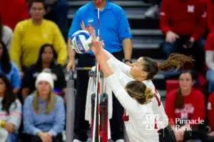 Nebraska Cornhuskers Merritt Beason (13) and Andi Jackson (15) block a shot against the Long Island Sharks in the third set during the first round of the NCAA volleyball championships on Friday, December 1, 2023, in Lincoln, Neb. Photo by John S. Peterson.