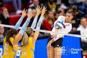 Nebraska Cornhusker Merritt Beason (13) spikes the ball past the Long Island Sharks in the second set during the first round of the NCAA volleyball championships on Friday, December 1, 2023, in Lincoln, Neb. Photo by John S. Peterson.