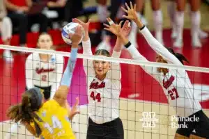 Nebraska Cornhusker Maggie Mendelson (44) and Nebraska Cornhusker Harper Murray (27) jump to block Long Island Shark Cristal Paulino Rubel (14) in the second sets during the first round of the NCAA volleyball championships on Friday, December 1, 2023, in Lincoln, Neb. Photo by John S. Peterson.