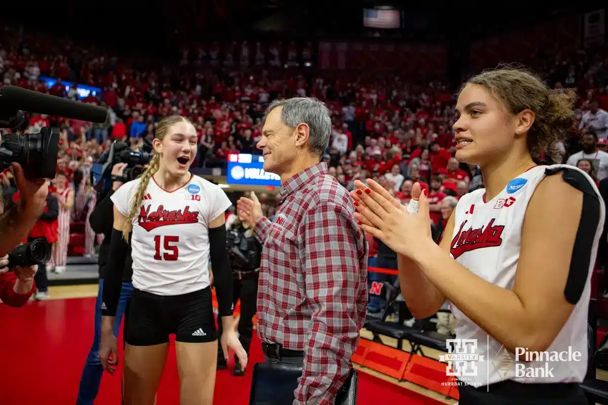 Nebraska Cornhuskers Andi Jackson (15), John Cook, and Bekka Allick (5) celebrate the win over the Arkansas Razorbacks during the Regional Championship match in the NCAA Volleyball Championship Thursday, December 7, 2023, Lincoln, Neb. Photo by John S. Peterson.