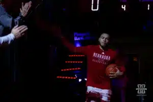 Nebraska Cornhusker guard C.J. Wilcher (0) gives a fan five while running out to the court to take on the Michigan State Spartans8 during the college basketball game Sunday, December 10, 2023, Lincoln, Neb. Photo by John S. Peterson.