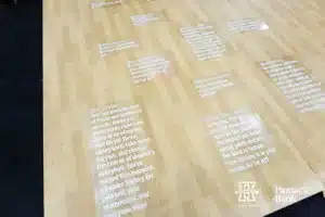 Inspiration in the corners of the floor where the benches are open practice before the NCAA Semi-Finals, Wednesday, December 13, 2023, Tampa, Florida. Photo by John S. Peterson.