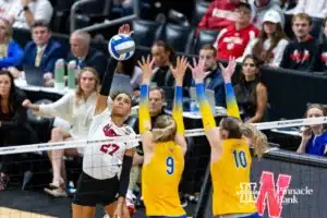 Nebraska Cornhusker outside hitter Harper Murray (27) spikes the ball against Pittsburgh Panthers middle blocker Emma Monks (9) and setter Rachel Fairbanks (10) during the NCAA Semi-Finals, Thursday, December 14, 2023, Tampa, Florida. Photo by John S. Peterson.