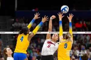 Nebraska Cornhusker middle blocker Bekka Allick (5) spikes the ball against Pittsburgh Panthers outside hitter Torrey Stafford (4) and middle blocker Emma Monks (9) in the first set during the NCAA Semi-Finals, Thursday, December 14, 2023, Tampa, Florida. Photo by John S. Peterson.