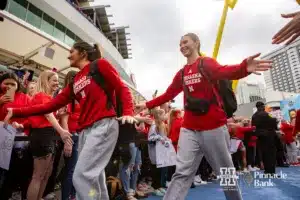 Nebraska Cornhusker libero Lexi Rodriguez (8) and Nebraska Cornhusker setter Bergen Reilly (2) giving five to the fans during the NCAA Finals on Sunday, December 17, 2023, in Tampa, Florida. Photo by John S. Peterson.