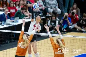 Nebraska Cornhusker outside hitter Merritt Beason (13) spikes the ball against Texas Longhorns outside hitter Jenna Wenaas (13) and middle blocker Bella Bergmark (5) in the second set during the NCAA Finals on Sunday, December 17, 2023, in Tampa, Florida. Photo by John S. Peterson.