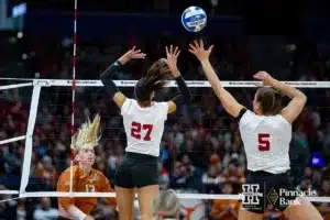 Nebraska Cornhusker outside hitter Harper Murray (27) and middle blocker Bekka Allick (5) jump to block Texas Longhorn outside hitter Jenna Wenaas (13) in the first set during the NCAA Finals on Sunday, December 17, 2023, in Tampa, Florida. Photo by John S. Peterson.