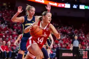 Nebraska Cornhusker guard Callin Hake (14) drives the baseline against Michigan Wolverine guard Jordan Hobbs (10) in the first quarter during a college basketball game on Wednesday, January 17, 2024, in Lincoln, Nebraska. Photo by John S. Peterson.