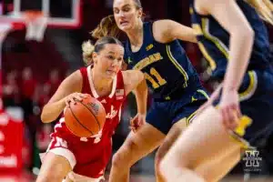 Nebraska Cornhusker guard Callin Hake (14) dribbles around Michigan Wolverine guard Greta Kampschroeder (11) in the second half during a college basketball game on Wednesday, January 17, 2024, in Lincoln, Nebraska. Photo by John S. Peterson.