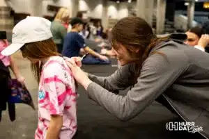 Omaha Supernovas Paige Briggs (13) sign her autograph for a young girl after the first professional volleyball match in the United States on Wednesday, January 24, 2024, in Omaha, Nebraska. Photo by John S. Peterson.