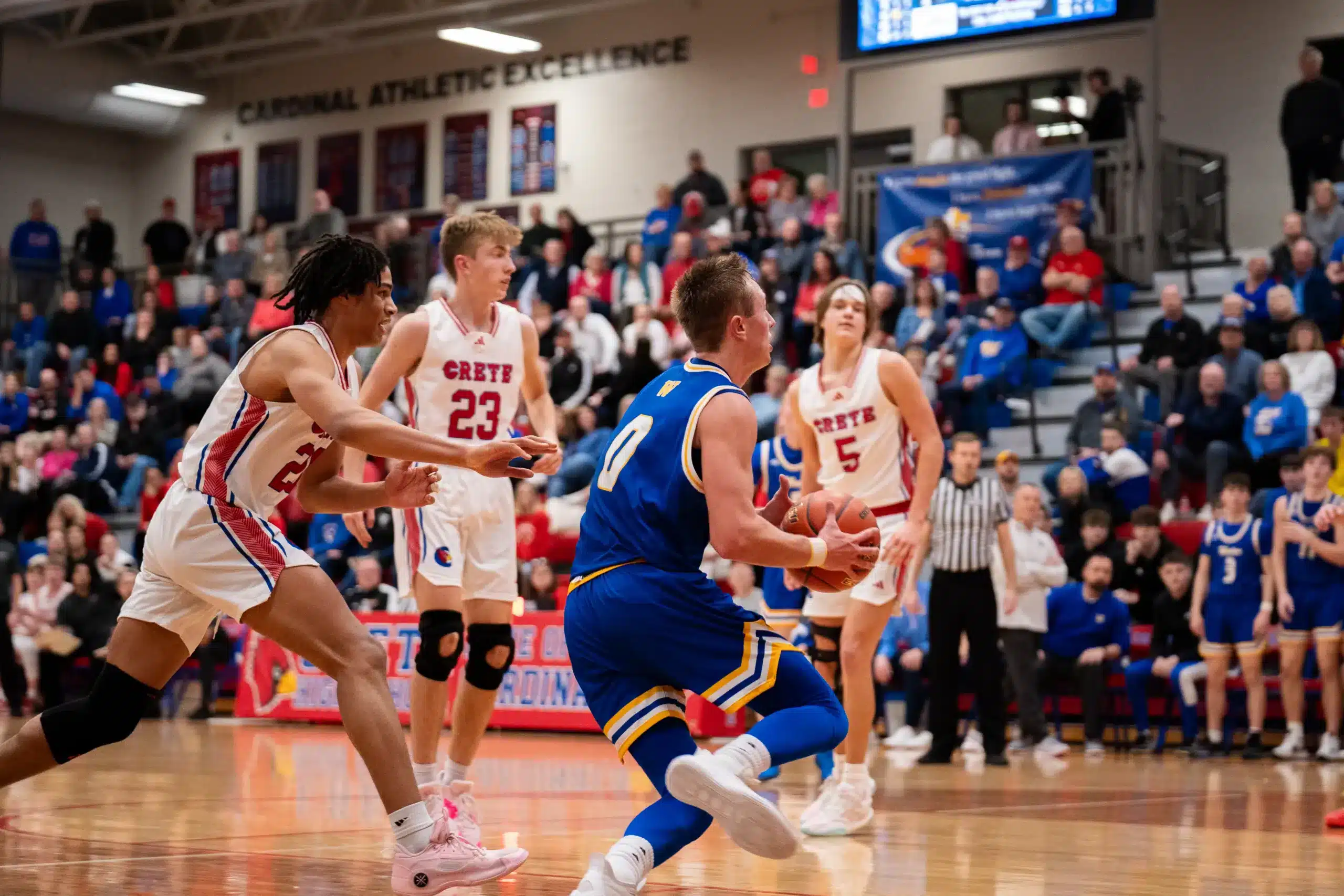 Wahoo's Marcus Glock (0) attacks the basket against Crete.