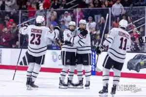 Omaha defenseman Kirby Proctor (3) celebrates his goal with Zach Urdahl (6) in the first period against Minn. Duluth during a college hockey match on Friday, February 2, 2024, in Omaha, Nebraska. Photo by John S. Peterson.