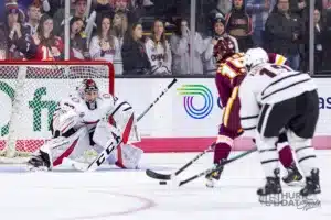 Omaha goaltender Simon Latkoczy (30) makes a save in the second period against Minn. Duluth forward Quinn Olson (15) during a college hockey match on Friday, February 2, 2024, in Omaha, Nebraska. Photo by John S. Peterson.