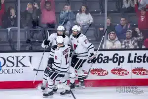 Omaha forward Zach Urdahl (6) celebrates his goal with teammates Nolan Sullivan (11) and Matt Miller (27) against Minn. Duluth during a college hockey match on Friday, February 2, 2024, in Omaha, Nebraska. Photo by John S. Peterson.