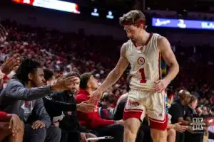 Nebraska Cornhusker guard Sam Hoiberg (1) gives five to the bench before sitting down against the Michigan Wolverines in the second half during a college basketball game on Saturday, February 10, 2024, in Lincoln, Nebraska. Photo by John S. Peterson.