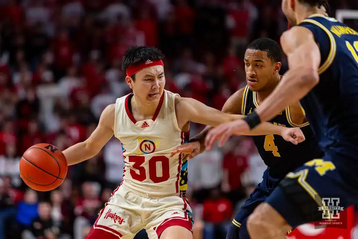 Nebraska Cornhusker guard Keisei Tominaga (30) drives to the basket against Michigan Wolverine guard Nimari Burnett (4) in the second half during a college basketball game on Saturday, February 10, 2024, in Lincoln, Nebraska. Photo by John S. Peterson.