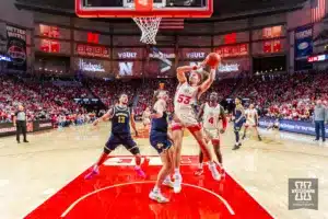 Nebraska Cornhusker forward Josiah Allick (53) makes a lay up against Michigan Wolverine forward Will Tschetter (42) in the first half during a college basketball game on Saturday, February 10, 2024, in Lincoln, Nebraska. Photo by John S. Peterson.