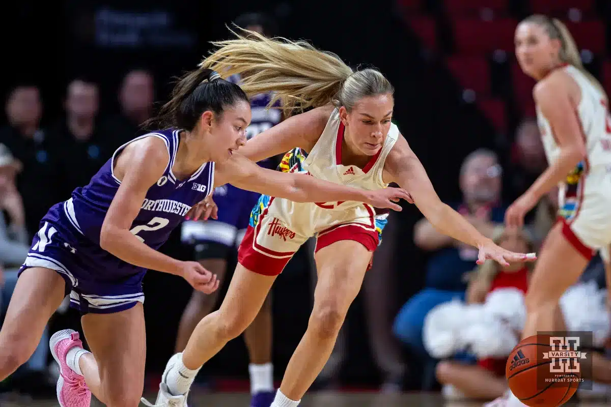 Nebraska Cornhusker forward Natalie Potts (22) reaches for the ball against Northwestern Wildcat guard Caroline Lau (2) in the first quarter during a college basketball game Tuesday, February 20, 2024, in Lincoln, Neb. Photo by John S. Peterson.