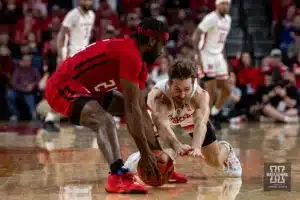 Nebraska Cornhusker guard Sam Hoiberg (1)dives for the ball against Rutgers Scarlet Knight forward Antonio Chol (21) during a college basketball game Sunday, March 3, 2024, in Lincoln, Neb. Photo by John S. Peterson.