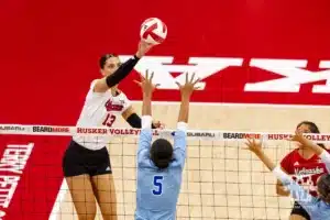 Nebraska Cornhusker Merritt Beason (13) taps the ball over Texas A&M CC Islander Tori Arrington (5) during the college volleyball game Friday, August 30, 2024, in Lincoln, Nebraska. Photo John S. Peterson.