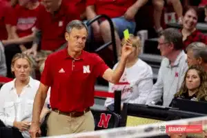 Nebraska Cornhusker head coach holds up the yellow card to challenge a call during the college volleyball against the Arizona State Sundevils match Friday, September 13, 2024, in Lincoln, Nebraska. Photo John S. Peterson.