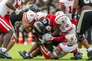 Nebraska Cornhusker linebacker John Bullock (5), Mikai Gbayor, and Malcolm Hartzog Jr. tackle Purdue Boilermaker running back Reggie Love III (23) during a college football game Saturday, September 28, 2024, in West Lafayette, Indiana. Photo by John S. Peterson.