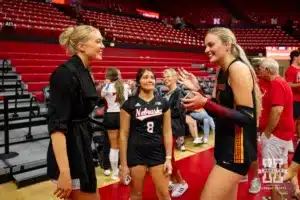 Former Nebraska players Lauren Stivrins and Ally Batenhorst (14) are excitied to see each other again after the volleyball match Sunday, September 29, 2024, in Lincoln, Nebraska. Photo by John S. Peterson.