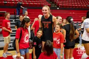 Nebraska Cornhuskers have a photo take with Ally Batenhorst after the volleyball match Sunday, September 29, 2024, in Lincoln, Nebraska. Photo by John S. Peterson.