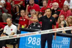 Nebraska Cornhusker assistant coach Jaylen Reyes gives a signal against the USC Trojans during a college volleyball match Sunday, September 29, 2024, in Lincoln, Nebraska. Photo by John S. Peterson.