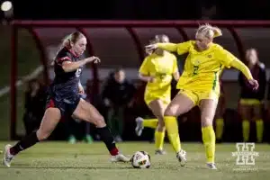 Nebraska Cornhusker forward Sarah Weber (42) dribbles the ball against Oregon Duck Lexi Lerwick (2) during a soccer match Thursday, October 17, 2024, in Lincoln, Nebraska. Photo by John S. Peterson.