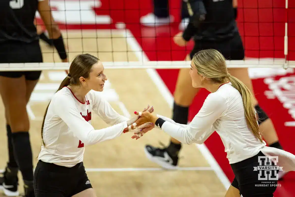 Nebraska Cornhusker Bergen Reilly (2) and Andi Jackson celebrate a point against the Purdue Boilermakers during a college volleyball match Friday, October 11, 2024, in Lincoln, Nebraska. Photo by John S. Peterson.