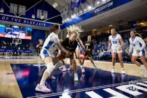 Creighton Bluejay guard Lauren Jensen (15) and Southwest Minnesota State Mustang forward Audrey Swanson (22) fight for the ball in the first half during a college women’s basketball game Thursday, October 30, 2024, in Lincoln, Nebraska. Photo by John S. Peterson.