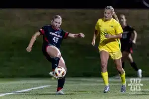 Nebraska Cornhusker forward Sarah Weber (42) kicks the ball for a shot against Oregon Duck forward Callan Harrington (12) in the first half during a soccer match Thursday, October 17, 2024, in Lincoln, Nebraska. Photo by John S. Peterson.