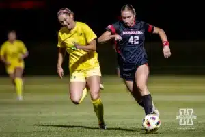 Nebraska Cornhusker forward Sarah Weber (42) dribbles the ball against Oregon Duck defender Ainsley Fink (20) in the the second half during a soccer match Thursday, October 17, 2024, in Lincoln, Nebraska. Photo by John S. Peterson.