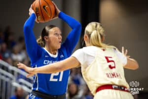 Creighton Bluejay guard Molly Mogensen (21) passes the ball against Nebraska Cornhusker guard Alberte Rimdal (5) in the first half during a women’s college basketball game Friday, November 22, 2024 in Omaha, Nebraska. Photo by John S. Peterson.