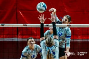 Shelton's Erin Gegg (13) spikes the ball against Overton's Daisy Ryan (12) during the semi-finals of the 2024 NSAA Volleyball Championships Friday, November 8, 2024, in Lincoln, Nebraska. Photo by Mike Sautter.