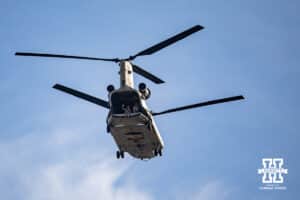 Military personnel waving from the back of the Chinnook helicopter during the flyover before a college football game between the Nebraska Cornhuskers and the Wisconsin Badgers Saturday, November 23, 2024 in Lincoln, Nebraska. Photo by John S. Peterson.