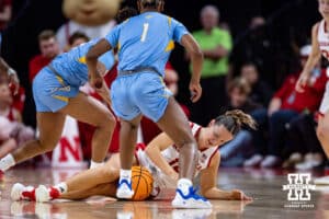 Nebraska Cornhusker guard Callin Hake (14) jumps on a loose ball against Southern Lady Jaguar guard Aniya Gourdine (1) during a college basketball game Tuesday, November 12, 2024, in Lincoln, Nebraska. Photo by John S. Peterson.