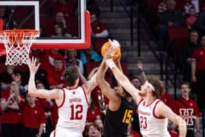 Nebraska Cornhusker guard Gavin Griffiths (12) and forward Andrew Morgan (23) fight for the rebound against Bethune-Cookman Wildcat forward Reggie Ward Jr. (15) in the first half during a college baskteball game Saturday, November 9, 2024, in Lincoln, Nebraska. Photo by John S. Peterson.