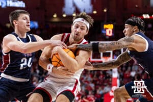 Nebraska Cornhusker guard Sam Hoiberg (1) holds on tight to the ball against Fairleigh Dickinson Knight guard Brayden Reynolds (24) and guard Terrence Brown (2) in the first half during a college basketball game Wednesday, November 13, 2024, in Lincoln, Nebraska. Photo by John S. Peterson.