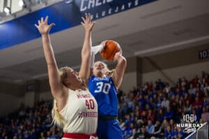 Creighton Bluejay guard Morgan Maly (30) makes a layup against Nebraska Cornhusker center Alexis Markowski (40) in the first half during a women’s college basketball game Friday, November 22, 2024 in Omaha, Nebraska. Photo by John S. Peterson.