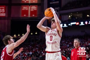 Nebraska Cornhuskers guard Connor Essegian (0) makes a three-point shot against South Dakota Coyotes guard Isaac Bruns (12) in the first half during a college basketball game Wednesday, November 27, 2024, in Lincoln, Nebraska. Photo by John S. Peterson.